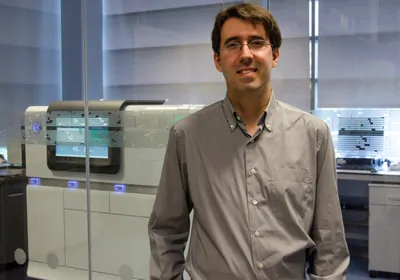 man standing in front of gene sequencing machines
